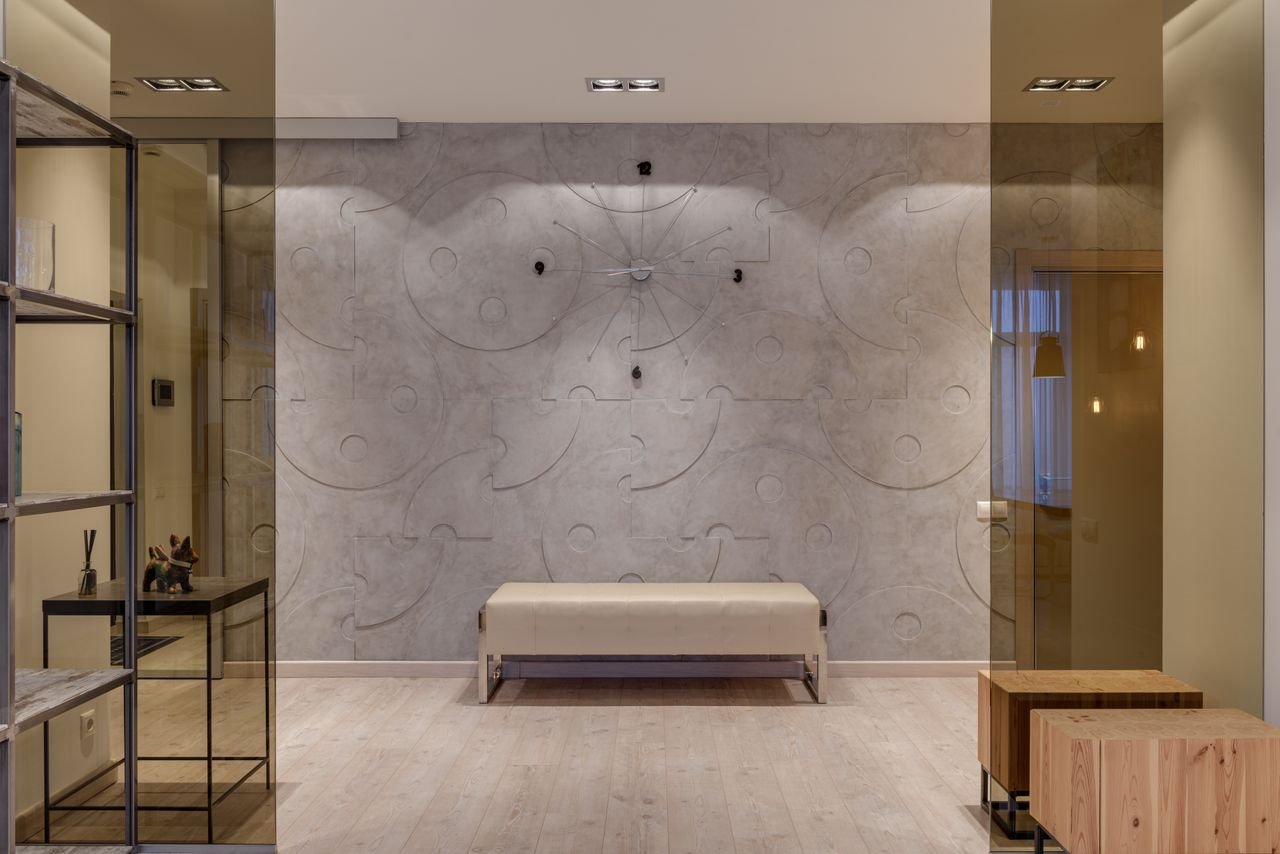 Interior of contemporary cozy hall with glass entrance and textured walls in flat